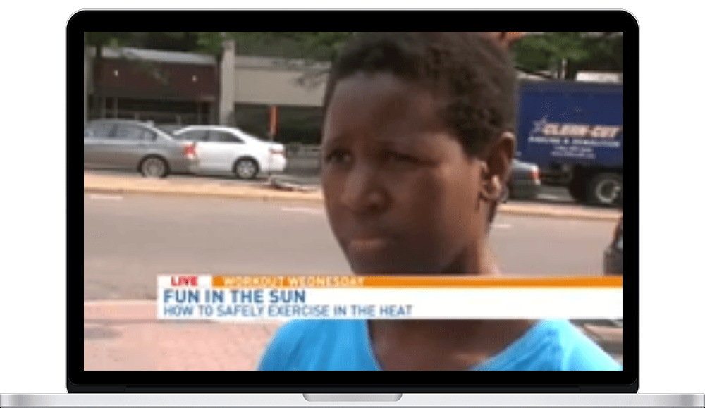 A young boy is talking to the news on tv.