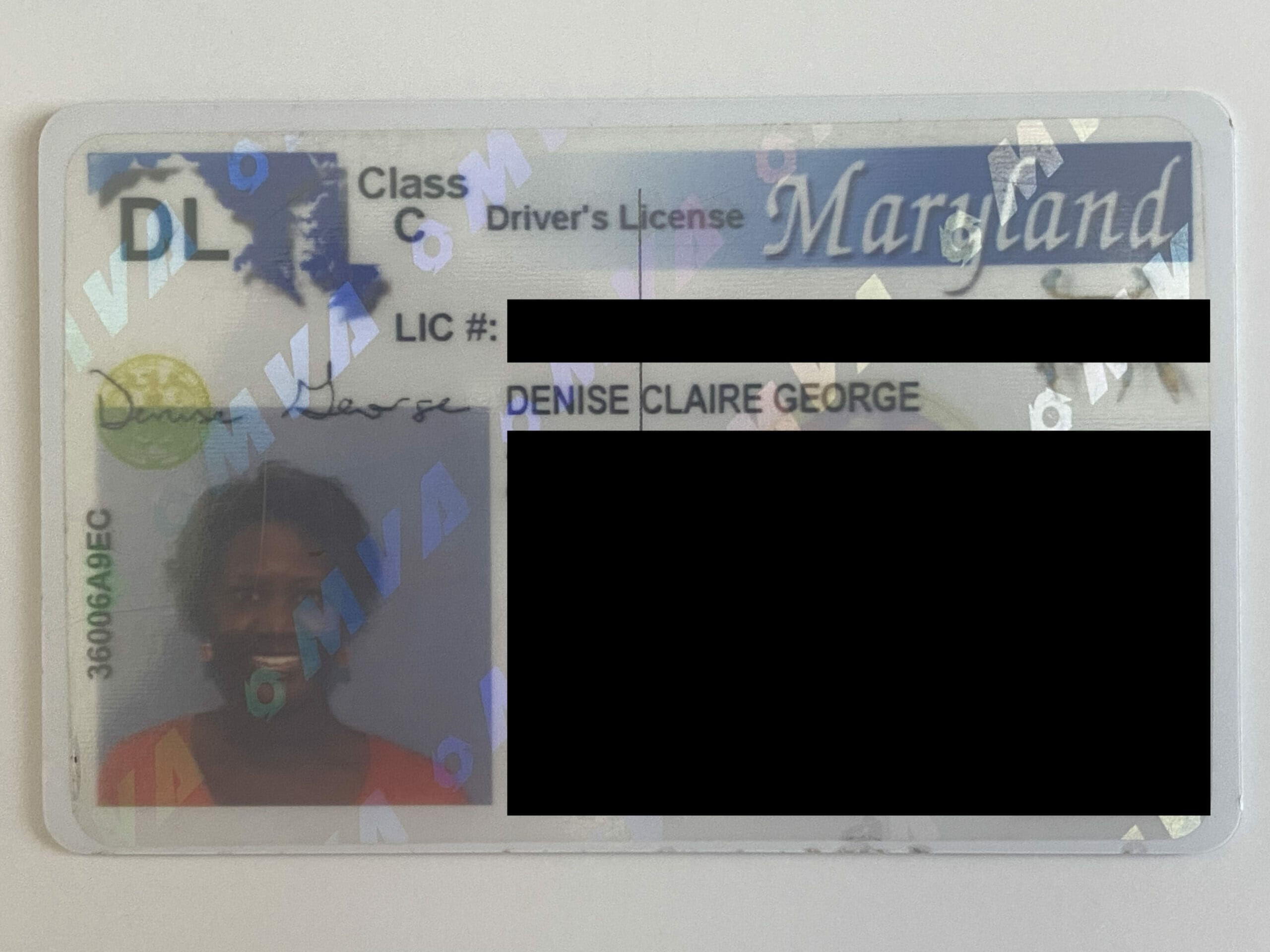 A close up of a driver 's license with a black spot