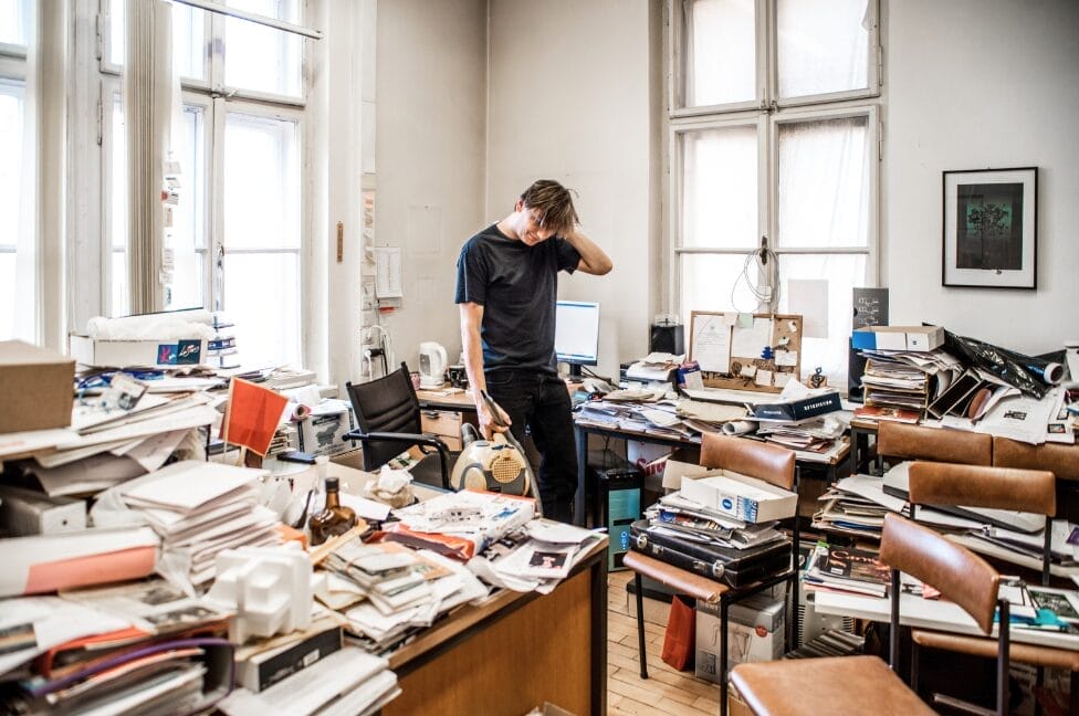 picture of a man in a disorganized office