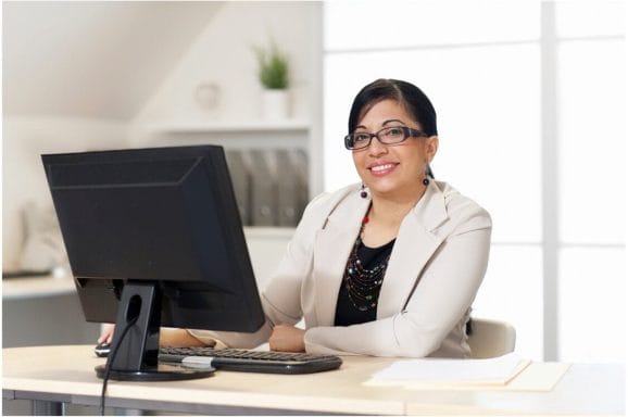 image of a woman sitting at a desk