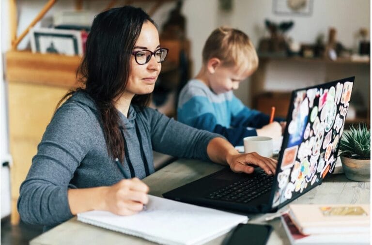 working mother looking at laptop