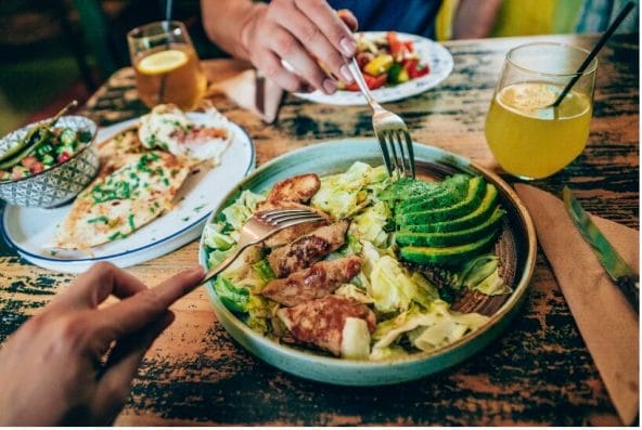 bowl of salad with chicken and avocado