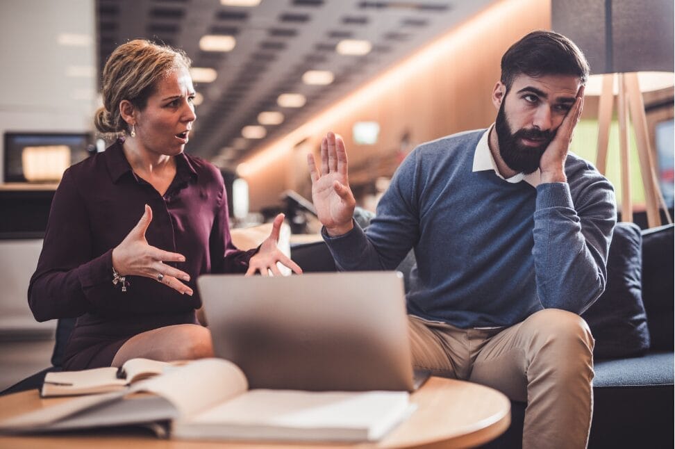 man pushing away comments from female employee