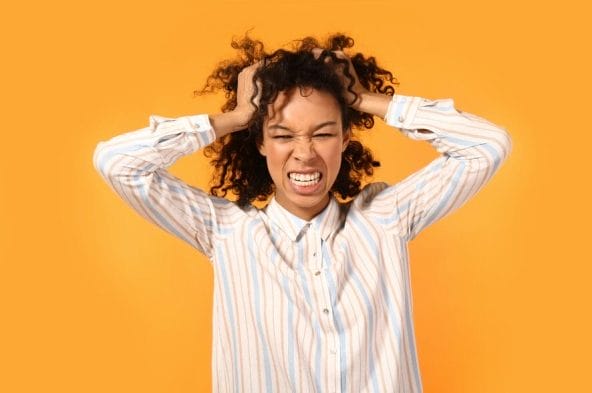 picture of woman putting hands into hair