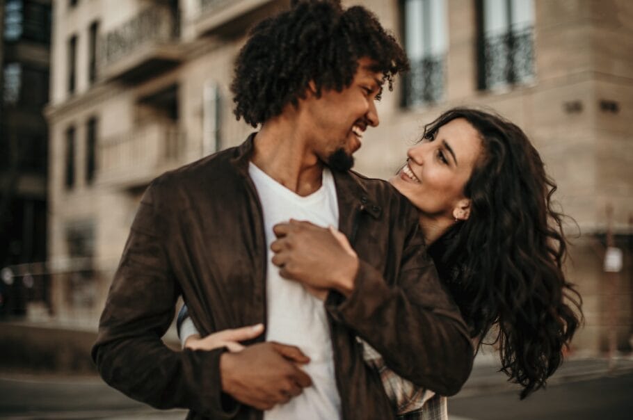 woman cuddling man from behind