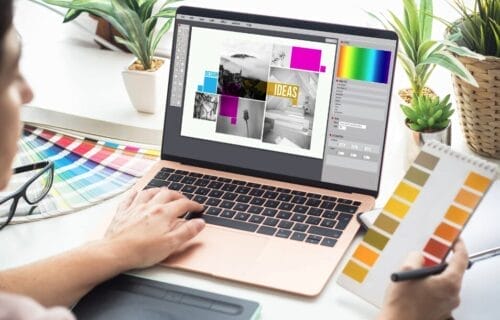 woman-holding-a-color-pallete-while-looking-at-laptop
