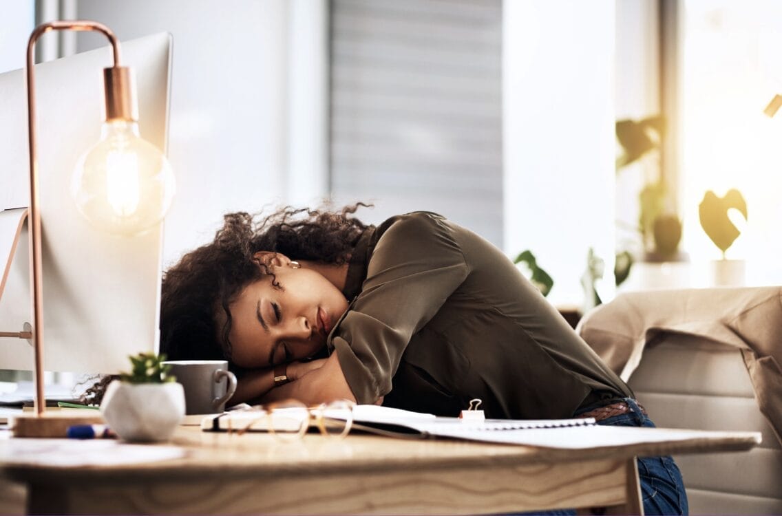 exhausted woman at desk