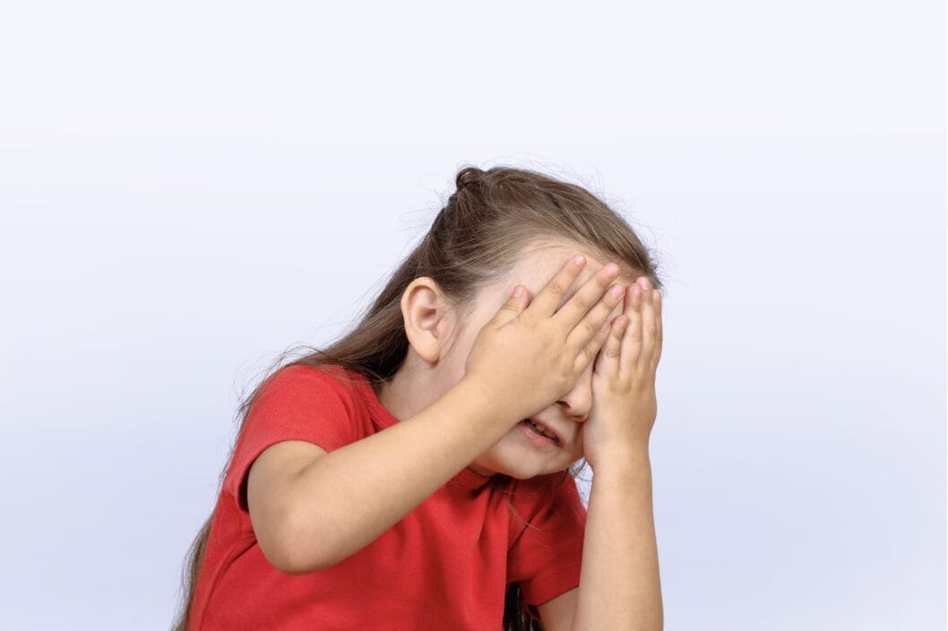 image of a little girl covering her eyes