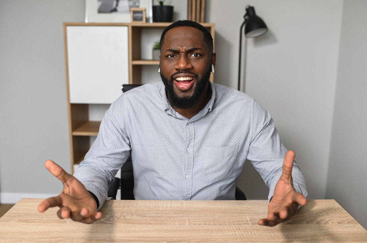 man with arms stretched out frustrated