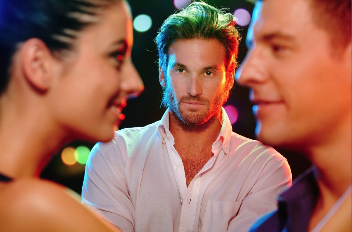 man staring at two people with jealously