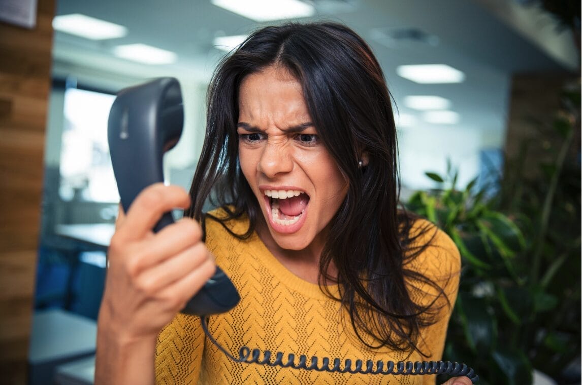 emotionally distressed woman yelling into phone