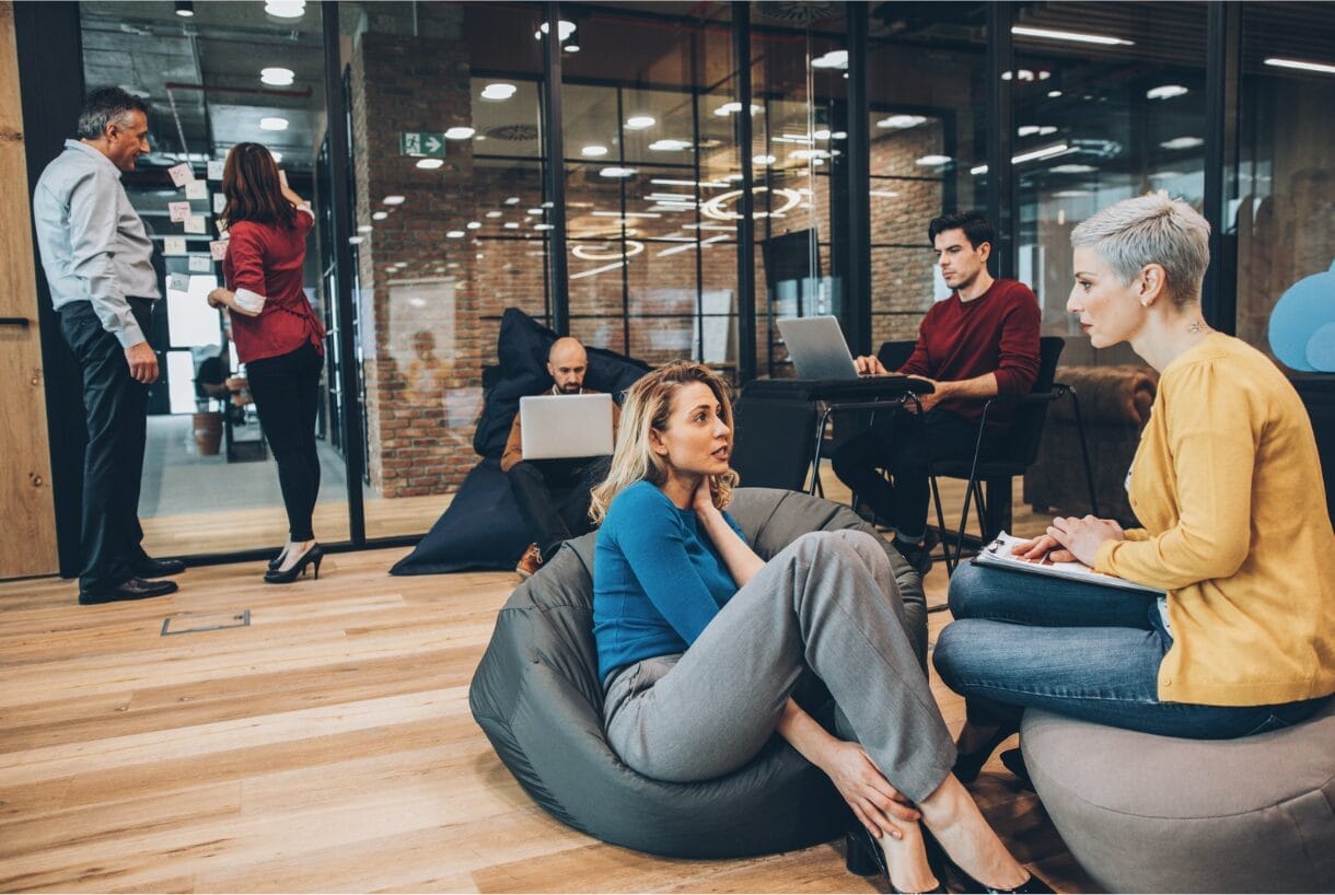 coworkers sitting and talking at office space