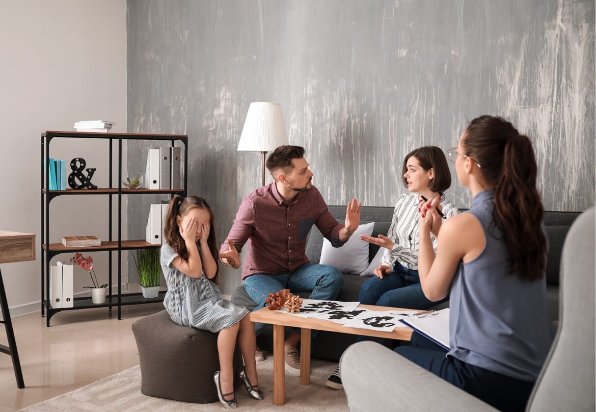 family arguing in family counseling with upset girl