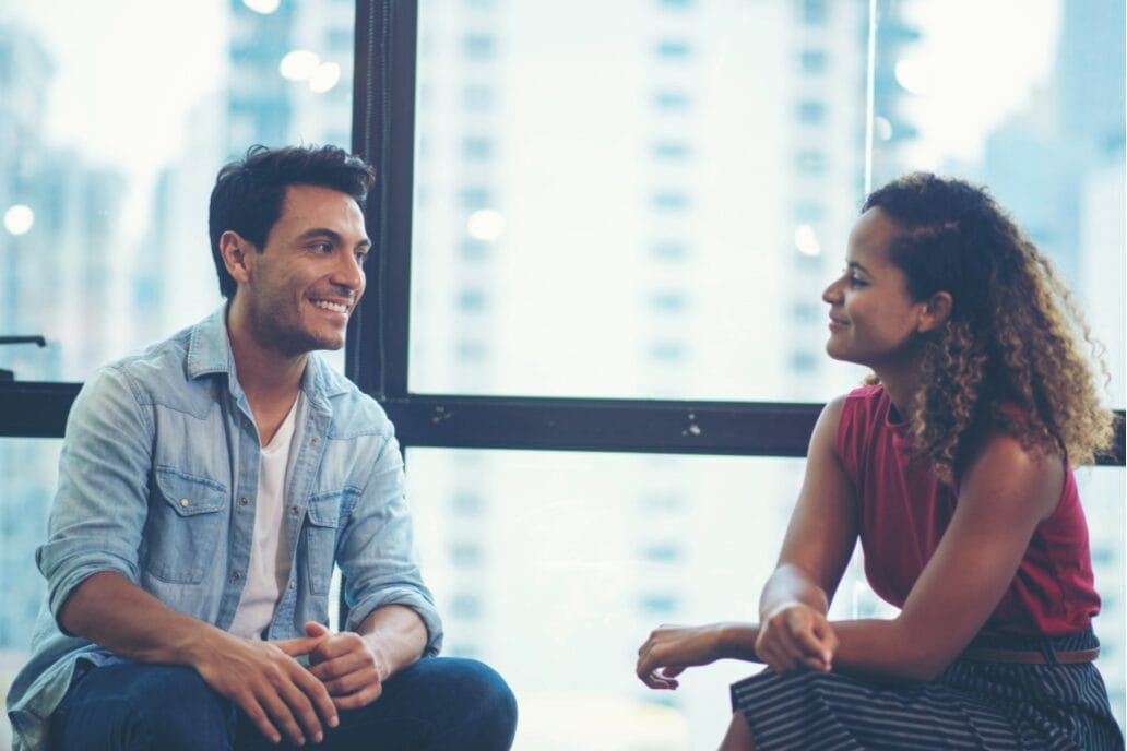 man and woman talking while seated