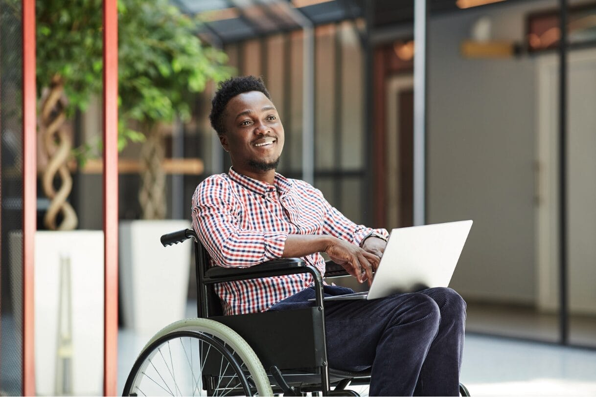 man in wheelchair smiling and looking confident