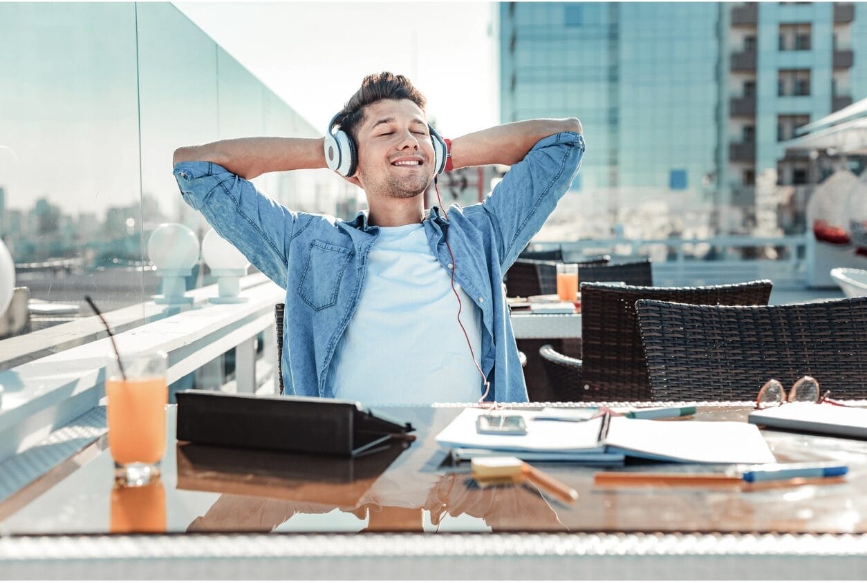 man relaxed with arms extended