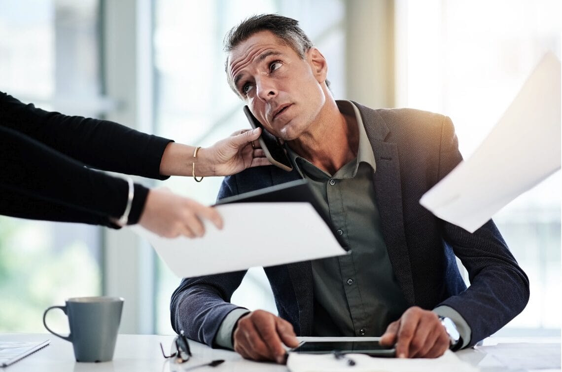 man trying to talk on phone while looking at screen