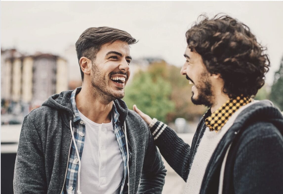 two men talking and laughing