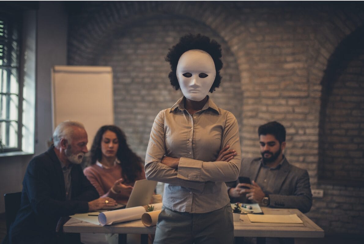 woman standing in office wearing mask