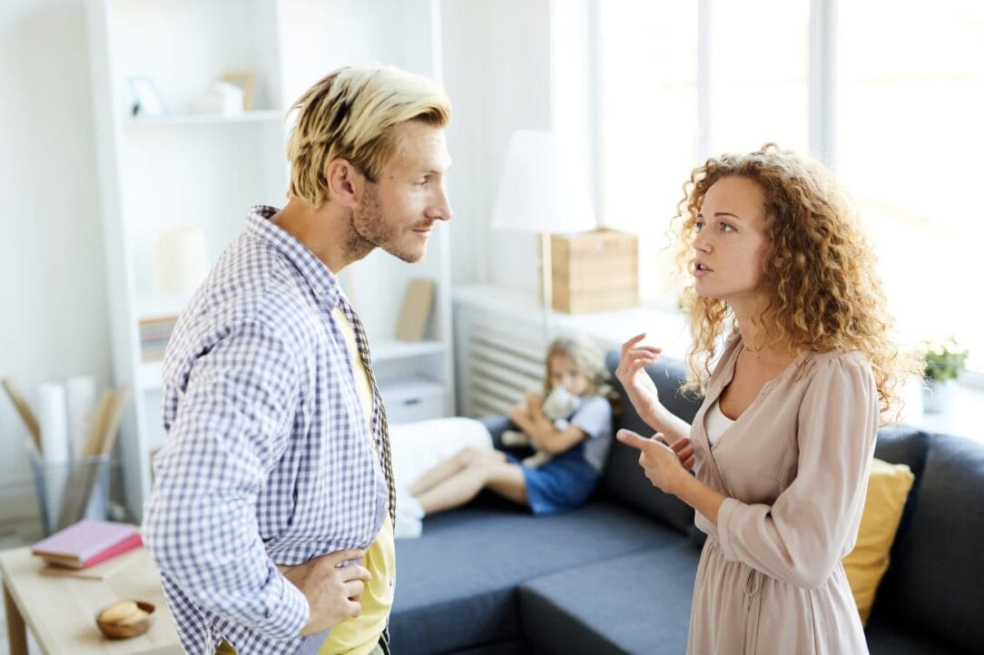 woman yelling at man while child watches