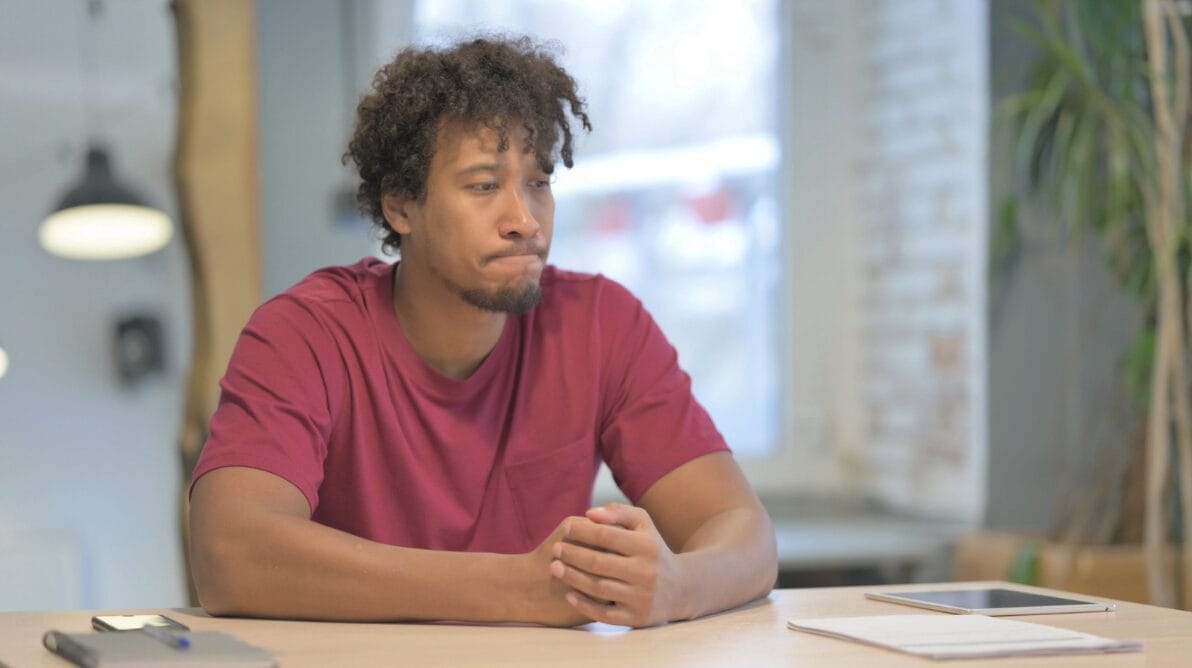 distraught looking man at table