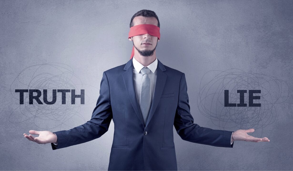 man blindfolded and truth from lie signs