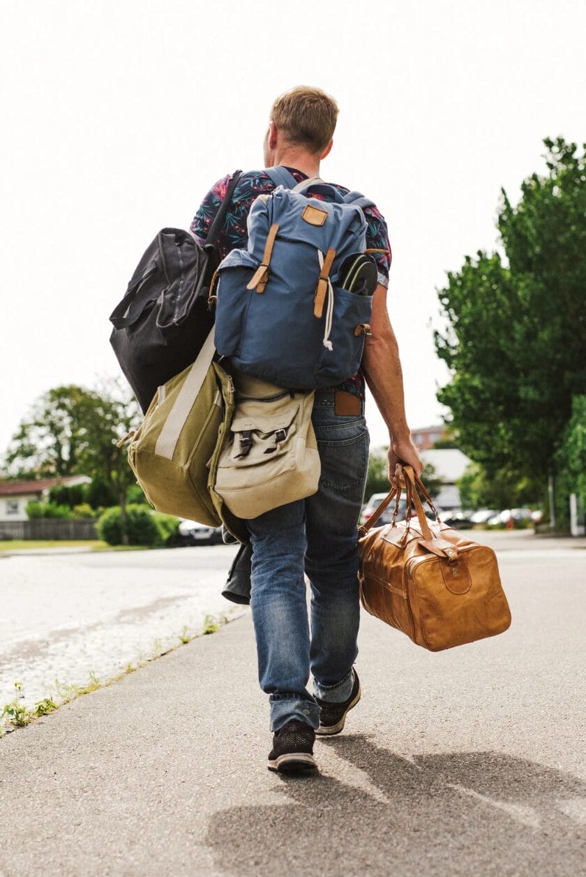 man walking carrying stuff