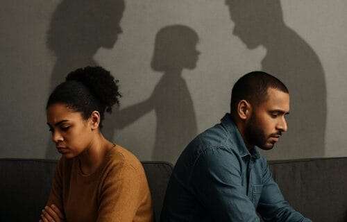 Two emotionally distant adults sit back-to-back, their shadows revealing a parent-child dynamic, symbolizing how childhood trauma repeats in adult relationships.