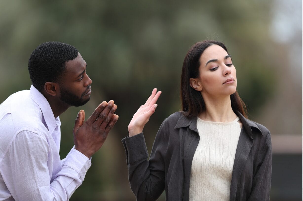 man begging woman