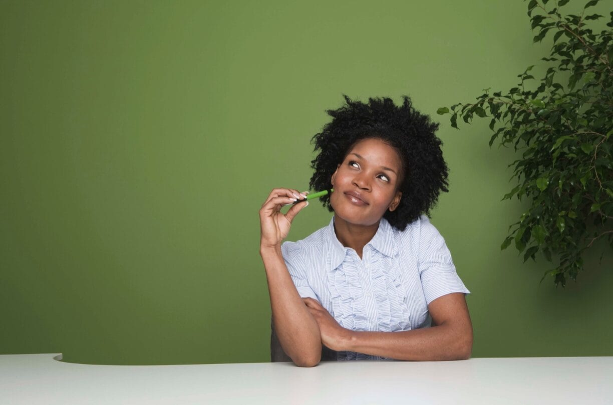 woman at desk day dreaming