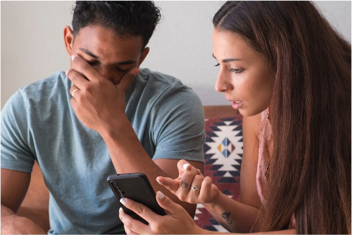 woman confronting man with phone