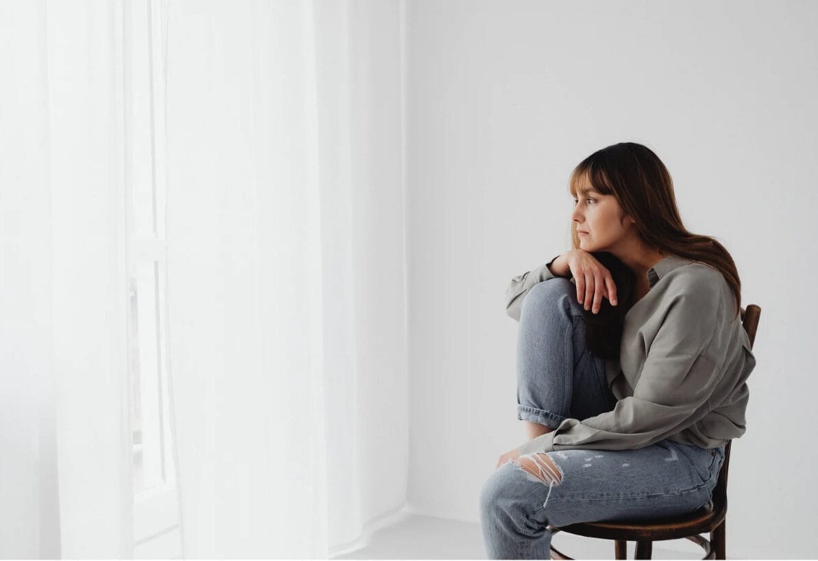 woman on chair looking at window