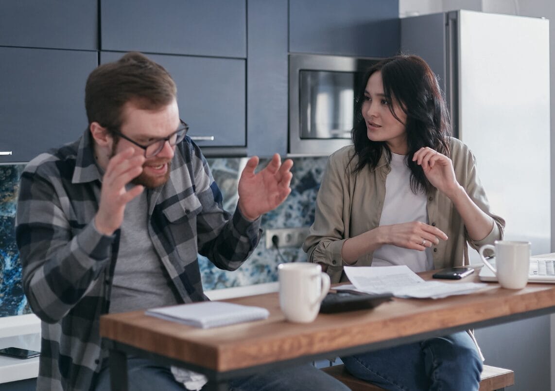 anxious man reacting poorly to a woman while at a desk