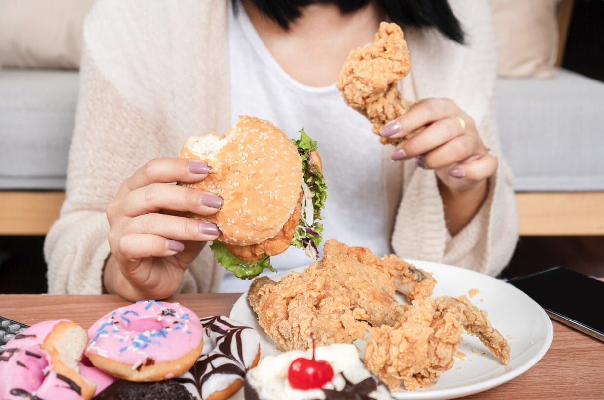 woman with a variety of food on her table