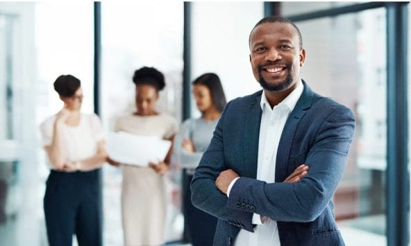 black man in front of others at work