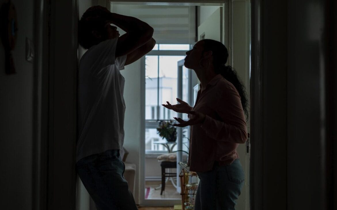 couple arguing in corner