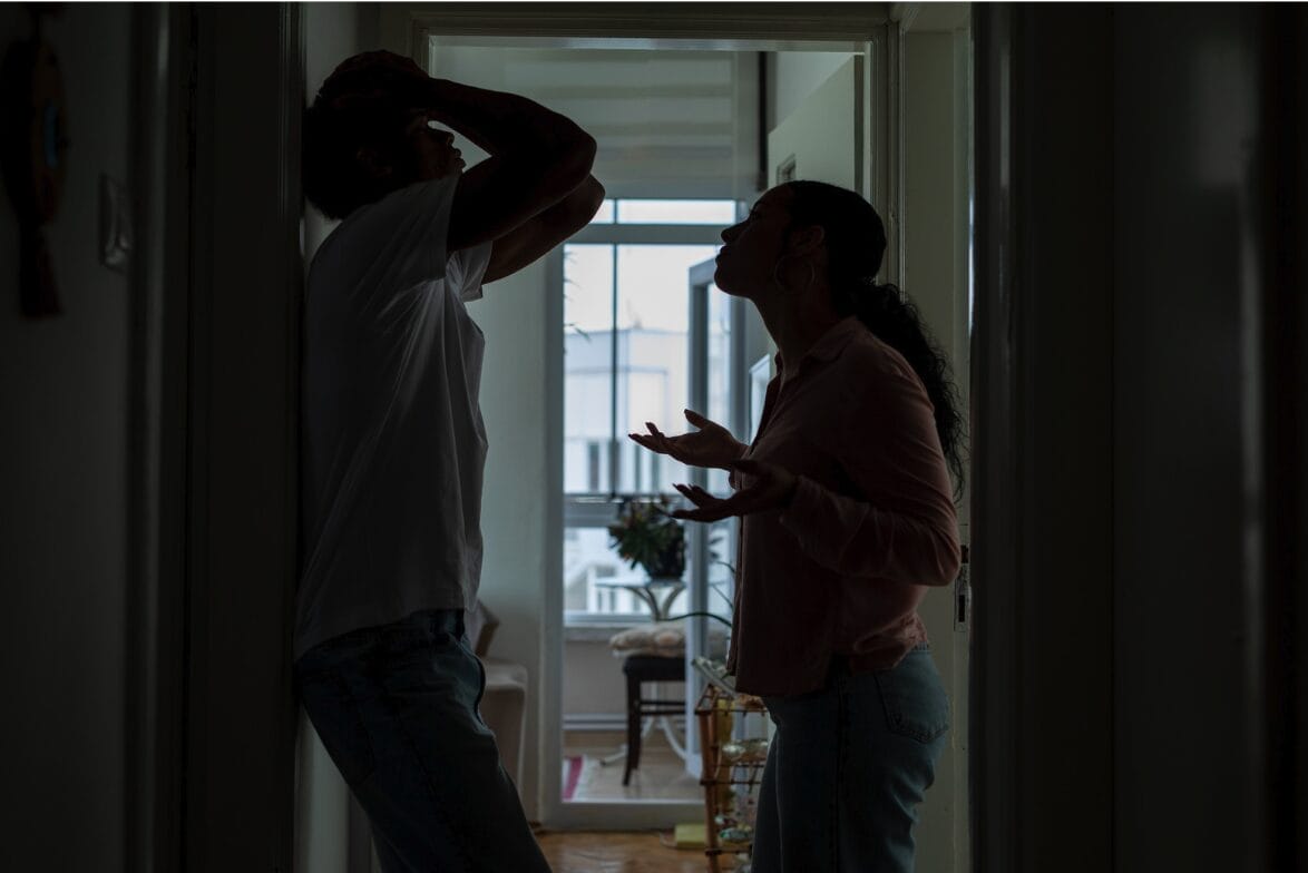 couple arguing in corner