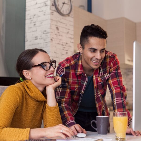 couple working, woman sitting man leaning