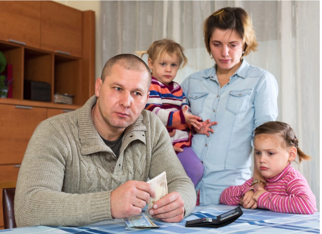 man upset while holding money in his hands