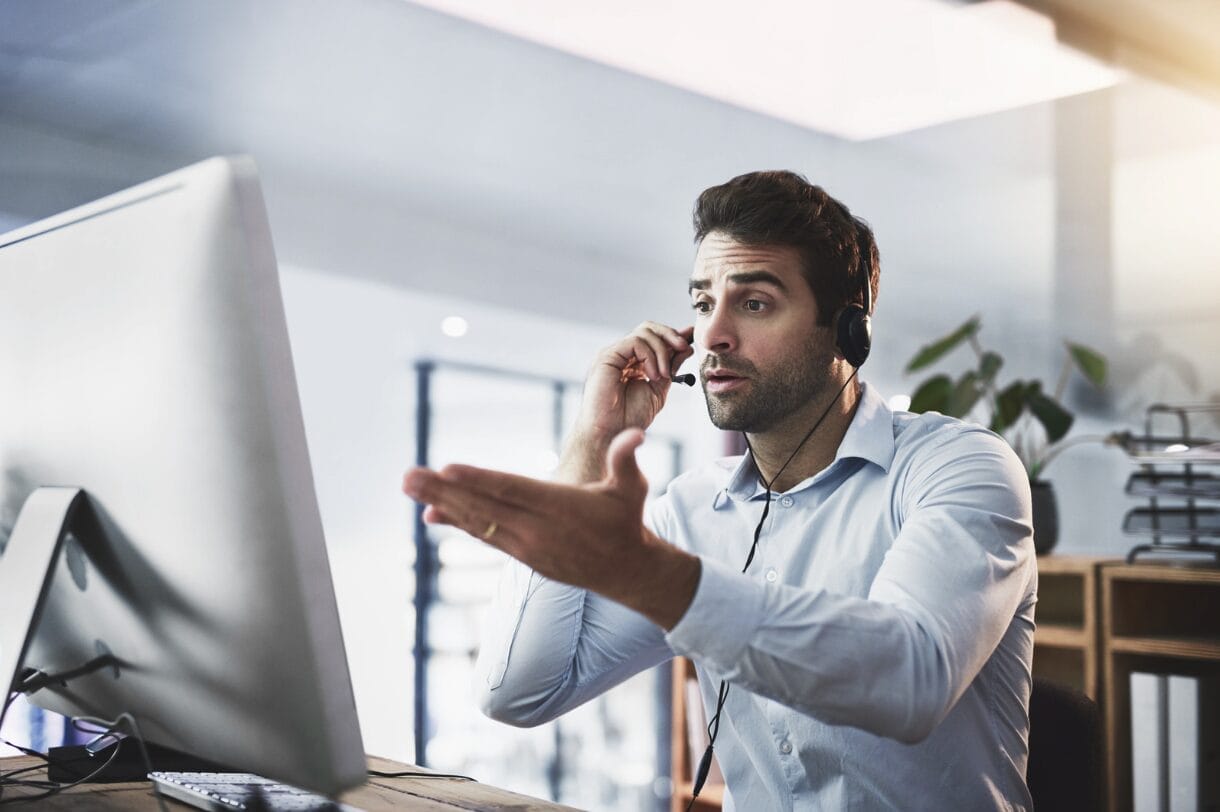 man in heated online conversation wearing headphone