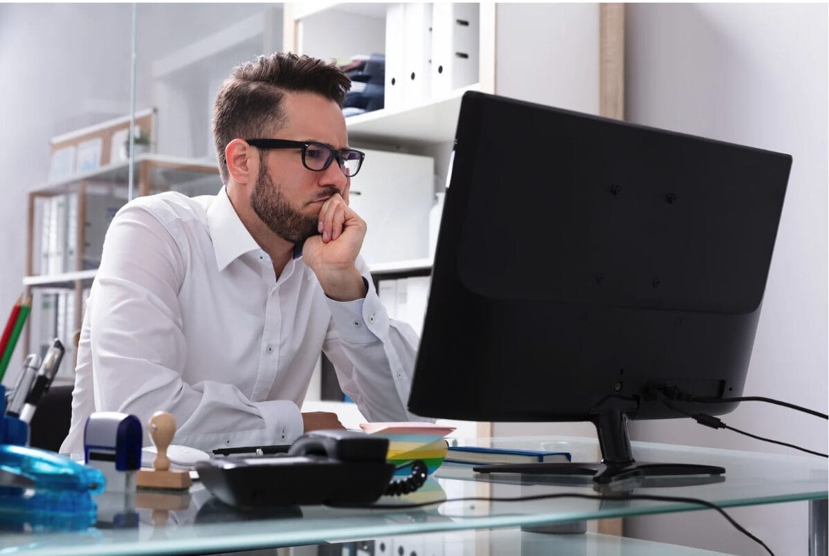 man looking at computer thoughtfully