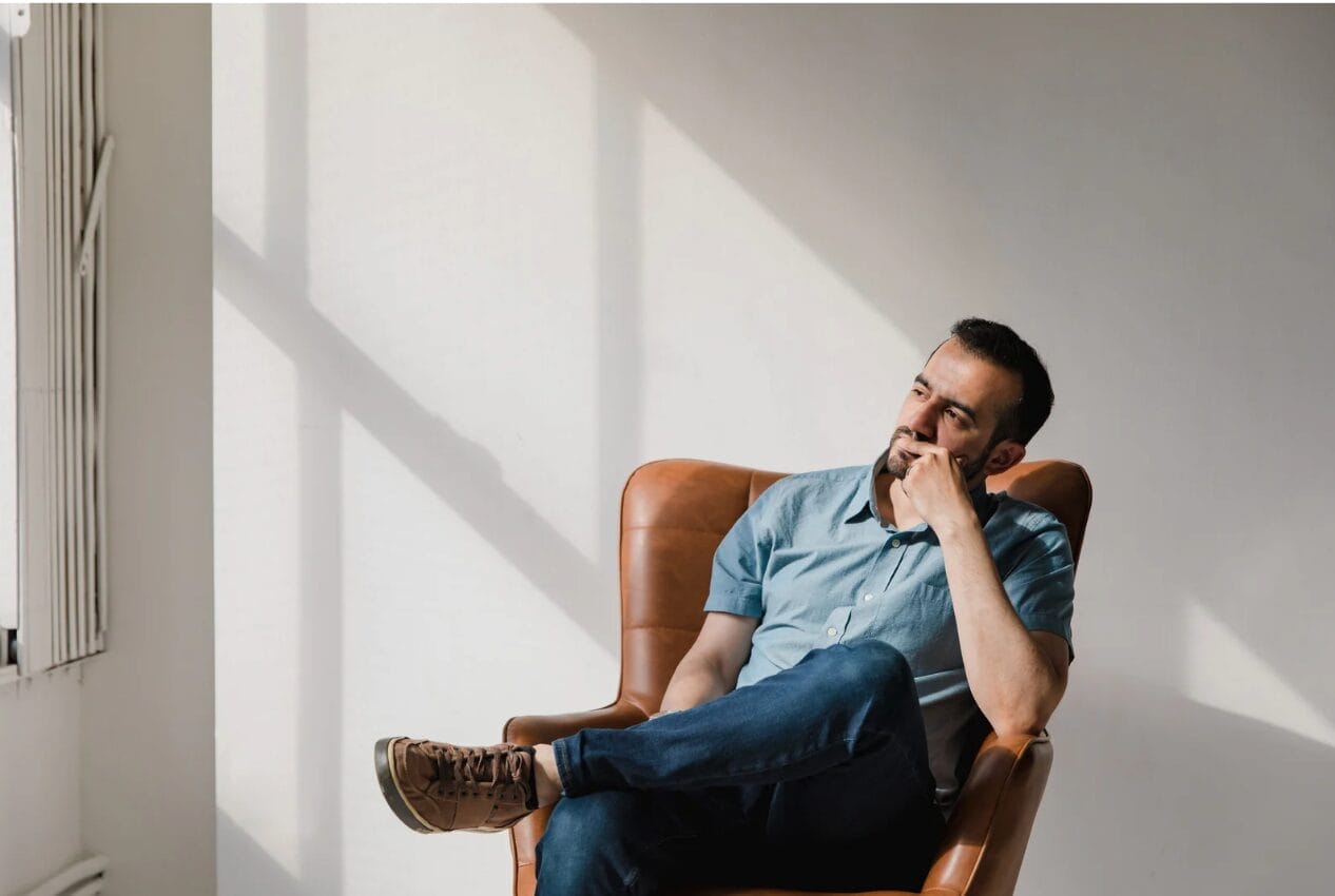 man sitting on chair thinking