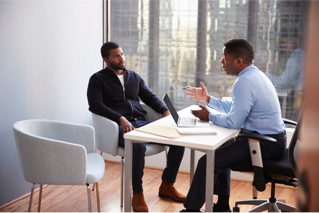 two black men in a client meeting