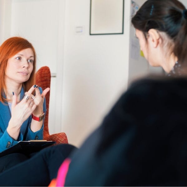 two white women talking in meeting