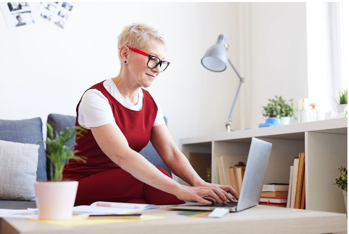 older woman at work wearing red