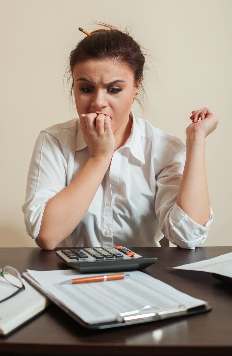 woman anxious while looking at calculator