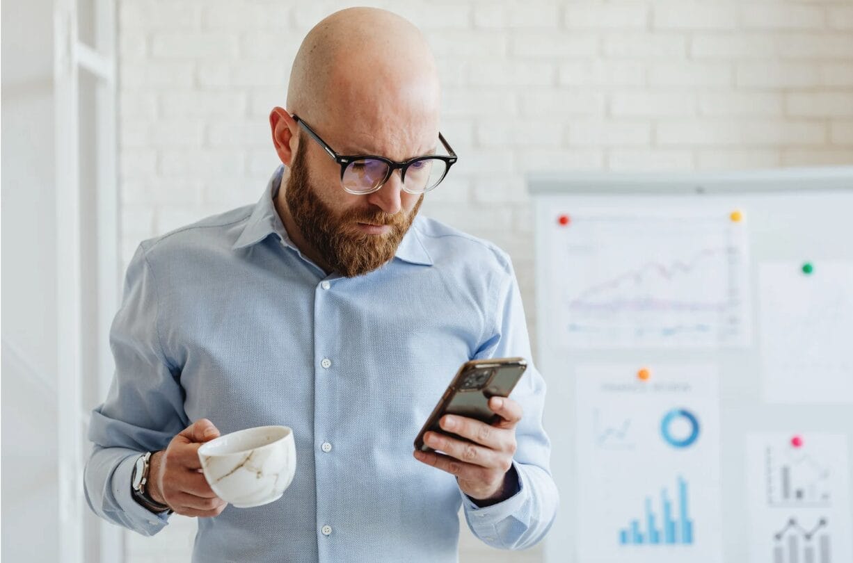 bald man looking at his phone