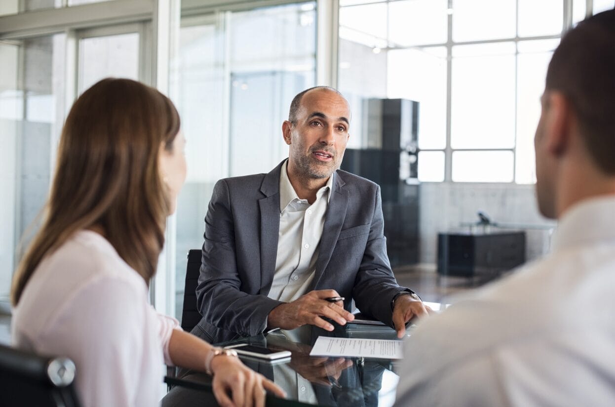 man and woman talking with a client