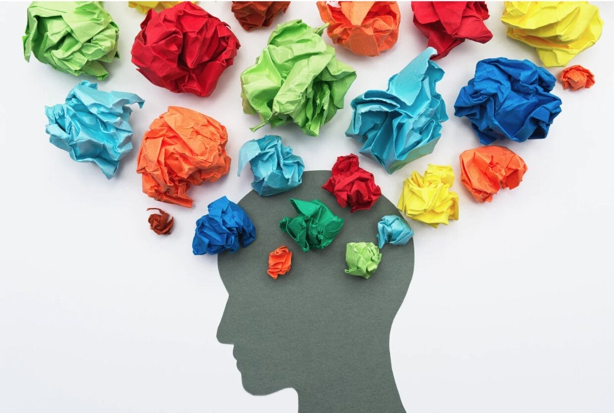 brain with colored paper above it.