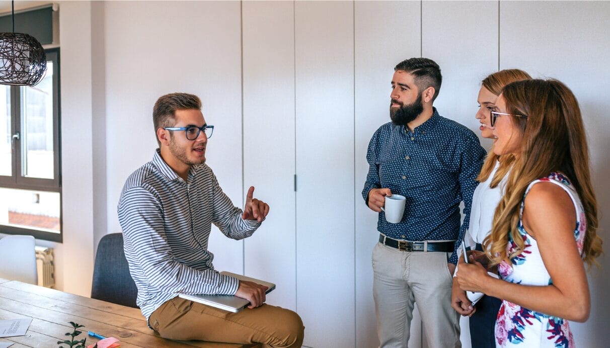 man sitting while talking with others